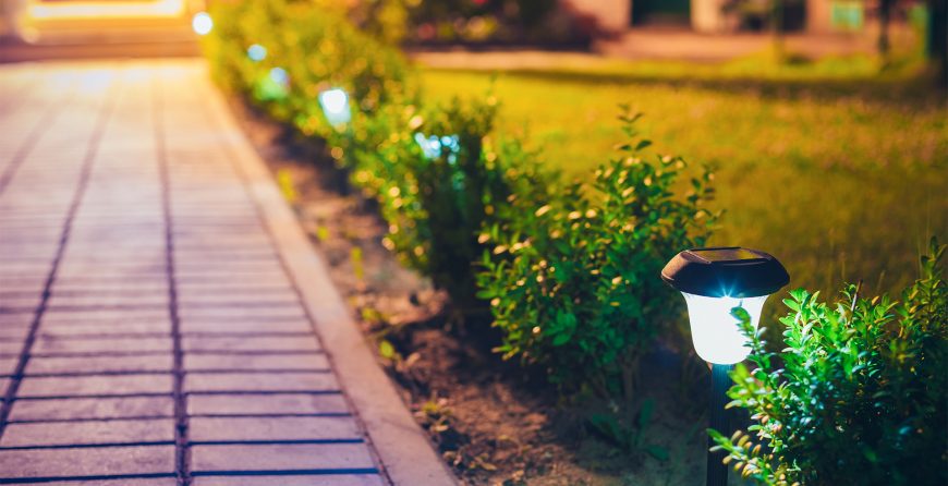 Solar light on garden with brick path